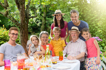 Family reunion around a picnic table in a beautiful garden