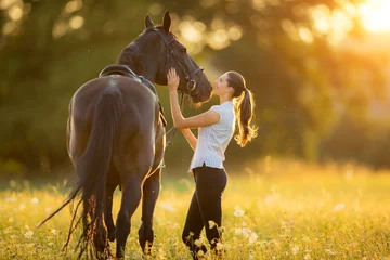 Foto op Canvas Young woman with her horse in evening sunset light © Jag_cz