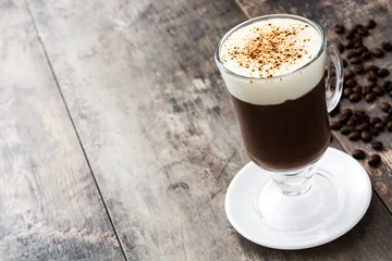  Irish coffee in glass on wooden table   © chandlervid85