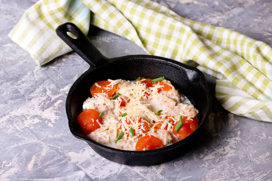 Homemade gnocchi with tomato sauce in frying pan