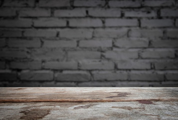Selected focus empty old wooden table and wall texture or old black brick wall blur background image. for your photomontage or product display
