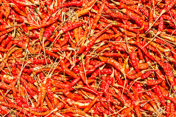 Fototapeta premium Hot and spicy Red Chilli ,Dried red chili,Pepper,Chillies as background for sale in a local food market,thai food ,close up,texture,spice medicinal properties.