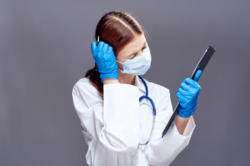 Young beautiful woman on a gray background, doctor, scientist, medicine