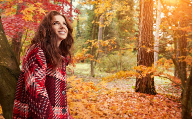 Beautiful woman in autumn park