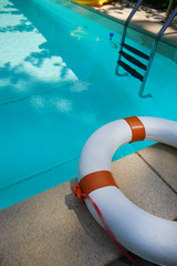 The lifebuoy is located on the edge of the pool
