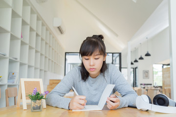 university students thinking and writing in the notebook