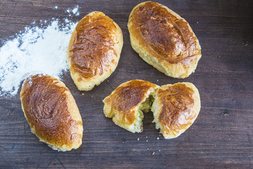 bakery concept/little pies on dark wooden background