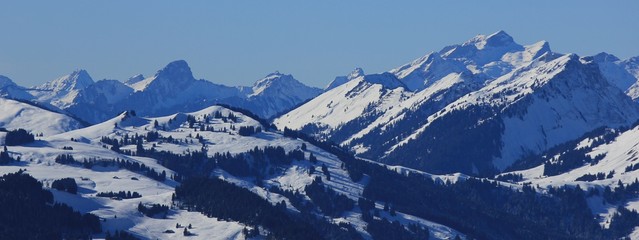 Snow covered mountains in Vaud Canton. View from mount Rellerli, Switzerland.