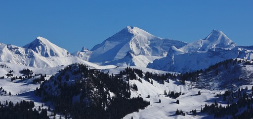 Saanersloch ski area and snow covered mountains in the Bernese Oberland, Switzerland.