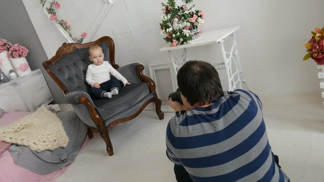 Photoshoot baby boy in sunny room
