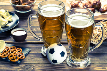 Appetizers and beer on the table for watch the football match.