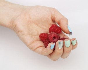 Berry raspberry in a woman's hand