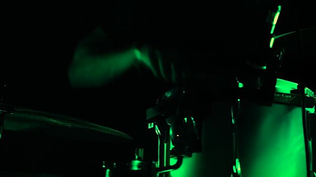 The drummer plays drums at a rock concert