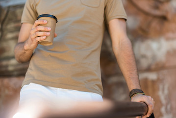 Youthful man having break time on city street