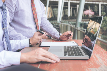Coworking, Business team meeting present, investor executive colleagues discussing new plan financial graph data on outdoors office table with laptop and tablet, Finance, accounting, investment