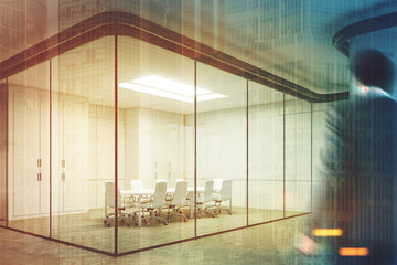 Corner of a glass meeting room, man