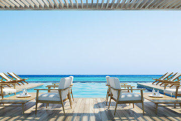 Armchairs and deck chairs near a pool