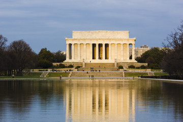 Reflection of the early morning sunshine covering the eastern facade of the Lincoln Memorial on the surface of the Reflecting Pool, National Mall, Washington DC