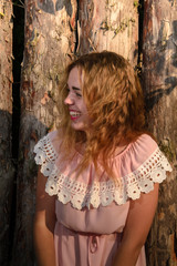 Fototapeta premium Wow. Close up portrait fashionable girl, teenager looking at camera and laughing isolated natural wooden wall. Positive human emotion