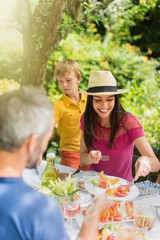 A family having lunch on the terrace in their garden