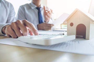 Man sign a home insurance policy on home loans, Agent holds loan investment chart graph documents...