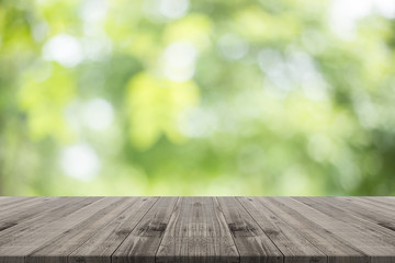 Naklejka na ściany i meble Wood table top on nature green blurred background,for montage your products