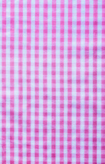 Pink checked cotton background close up view