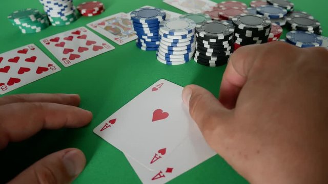Poker Player Moves Chips on Table at Casino. Casino Chips And Double Aces. Winner In Poker. Poker Player Going All-in. Poker Win Combination