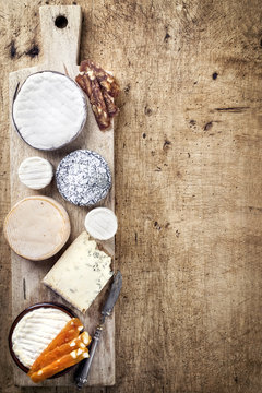 French Cheese Platter with Spanish Dulce de Membrillo as top view on a wooden board
