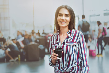 Happy smiling woman in waiting hall