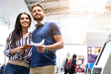 Merry couple standing in terminal