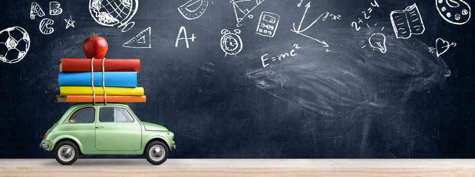 Back to school background. Car delivering books and apple against blackboard with education symbols.