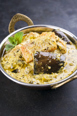 Traditional Indian Vegetable Curry with Sweet Potatoes and Eggplant as close-up in a Korai