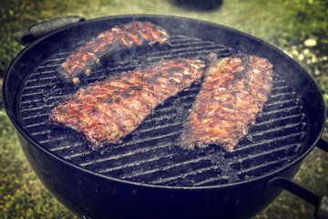 Barbecue Pork Spare Ribs as close-up on a kettle grill