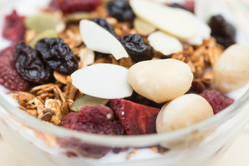 Closed up and blur breakfast healthy food, granola, musli, Organic oat, super food with honey, dried fruits and nuts in bowl
