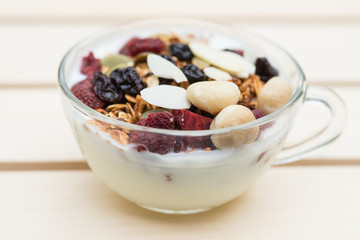Closed up and blur breakfast healthy food, granola, musli, Organic oat, super food with honey, dried fruits and nuts in bowl