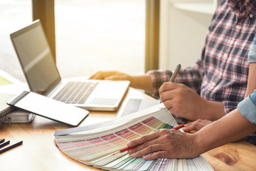 Young colleagues designers working together on a creative project and color samples for selection, Color swatch samples, Brainstorming Planning Partnership, creative graphic design working desktop