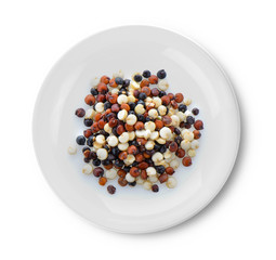 Quinoa seeds in plate on white background