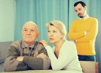 Man seriously talking with family