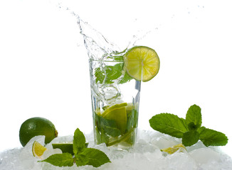 Mojito, a cool cocktail of lime and mint and soda, in a highball glass with a splash and ice, isolated on a white background
