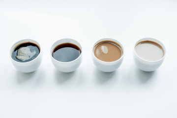 close-up view of different kinds of coffee in row isolated on white