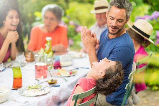 Three Generations Family Having Lunch In The Garden