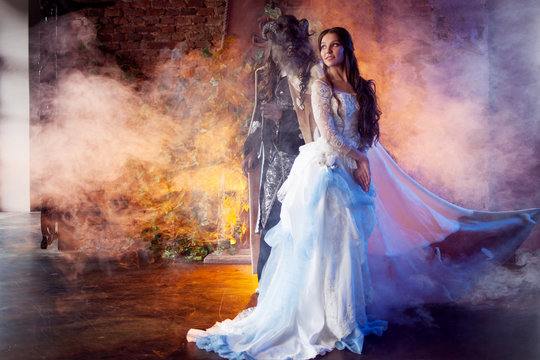 Beautiful girl and a monster, fairy tale, concept. Fine art photo.