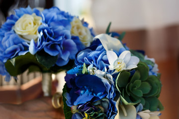 Blue and white wedding bouquets lie on the table