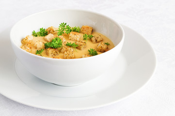 lentil soup puree decorated with croutons and parsley