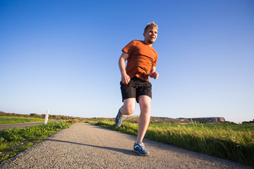 Man running outdoor sprinting for success. Male fitness runner sport athlete in sprint at great...