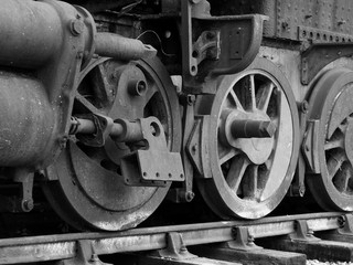 old steam locomotive with rusted wheels and missing parts
