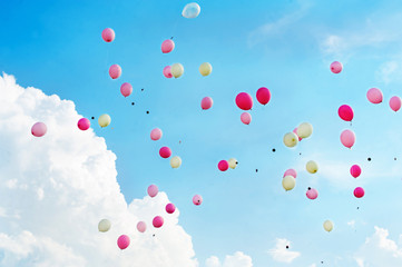 Wedding balloons rise in the sky