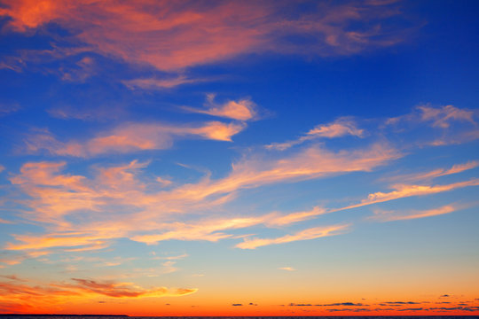 Fototapeta Pink clouds on a blue sky background after sunset