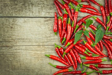 Fresh chili pepper on a wooden board. Growing chili. Healthy spice.